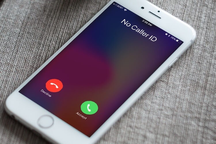 Smartphone displaying an incoming call from an unidentified caller.