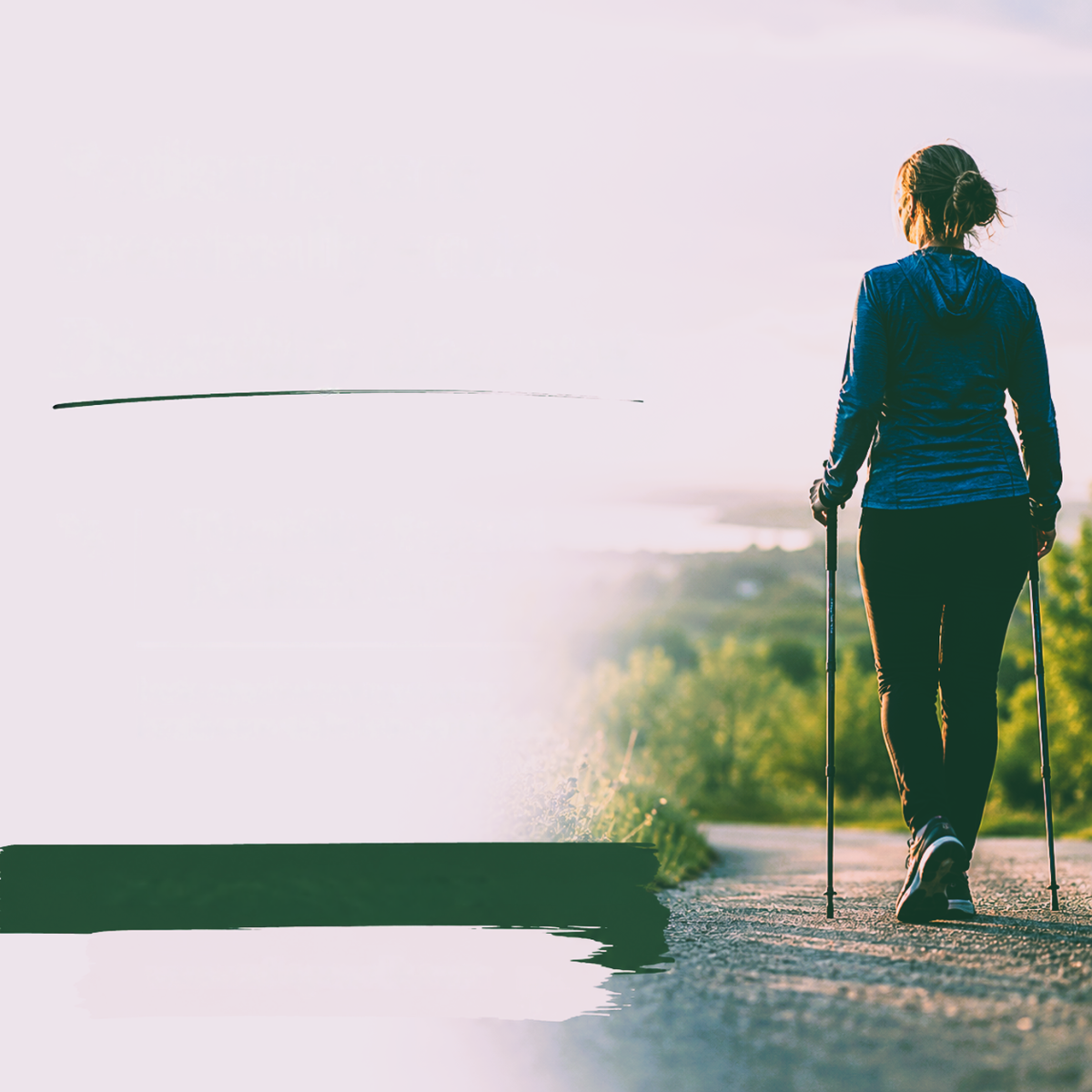Photograph from behind of a person using two walking poles on a sunlit paved path.
